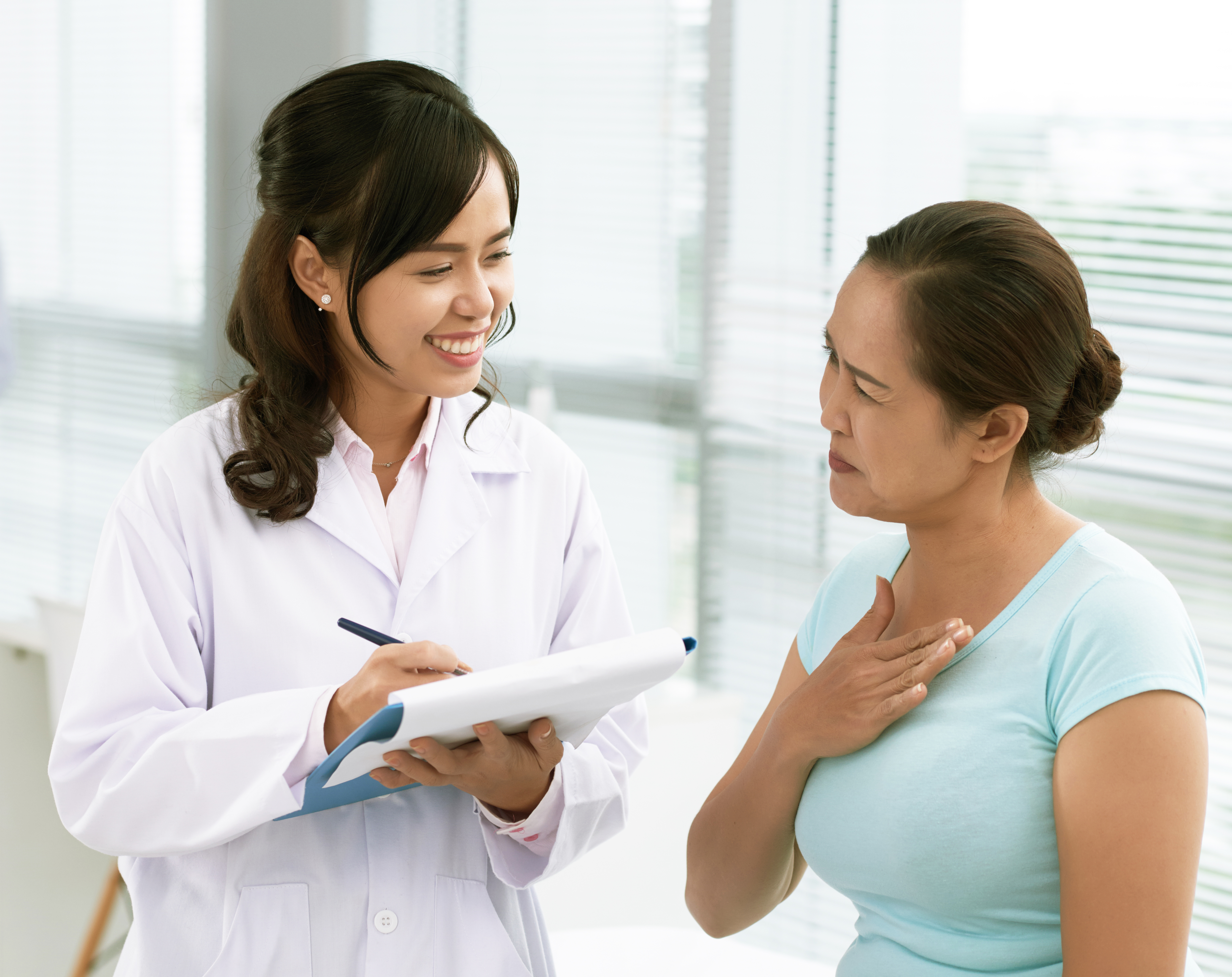 Doctor talking with patient about Wireless Cardiac Monitoring Device.