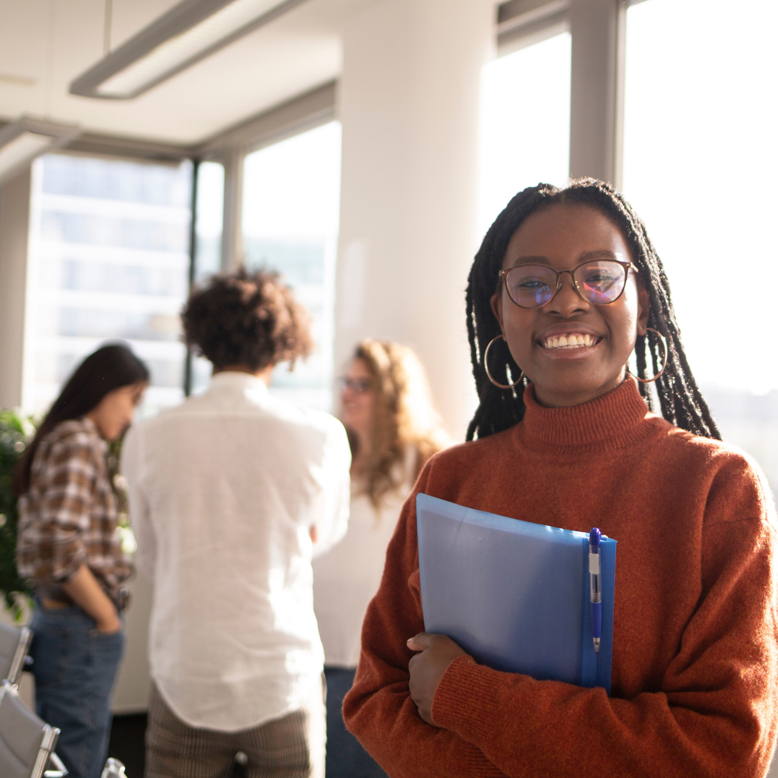 Girl smiling at camera showing youth excited to intern at Rhythm Express.